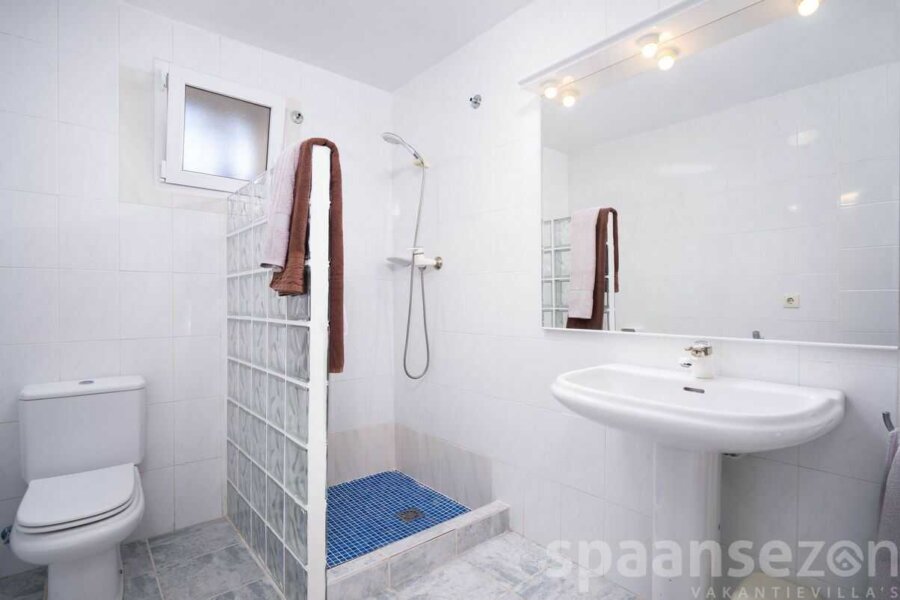 Salle de bain avec douche à l'italienne, lavabo et toilettes